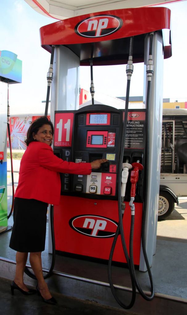 Minister of Trade and Industry Paula Gopee-Scoon points to the Fuel Verication Sticker on the fuel pump at the NP Munroe Road Service Station, Charlieville, on Wednesday. Photo by Vashti Singh