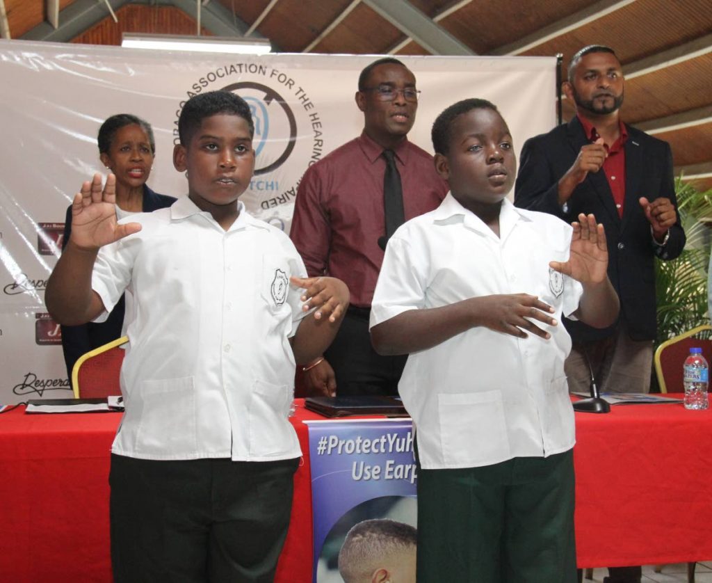 Students of the Cascade School for the Deaf sign the National Anthem at the launch of the Protect Your Ear national awareness campaign at the Dretchi compound, Wrightson Road, Port-of-Spain Wednesday. PHOTO BY AYANNA KINSALE