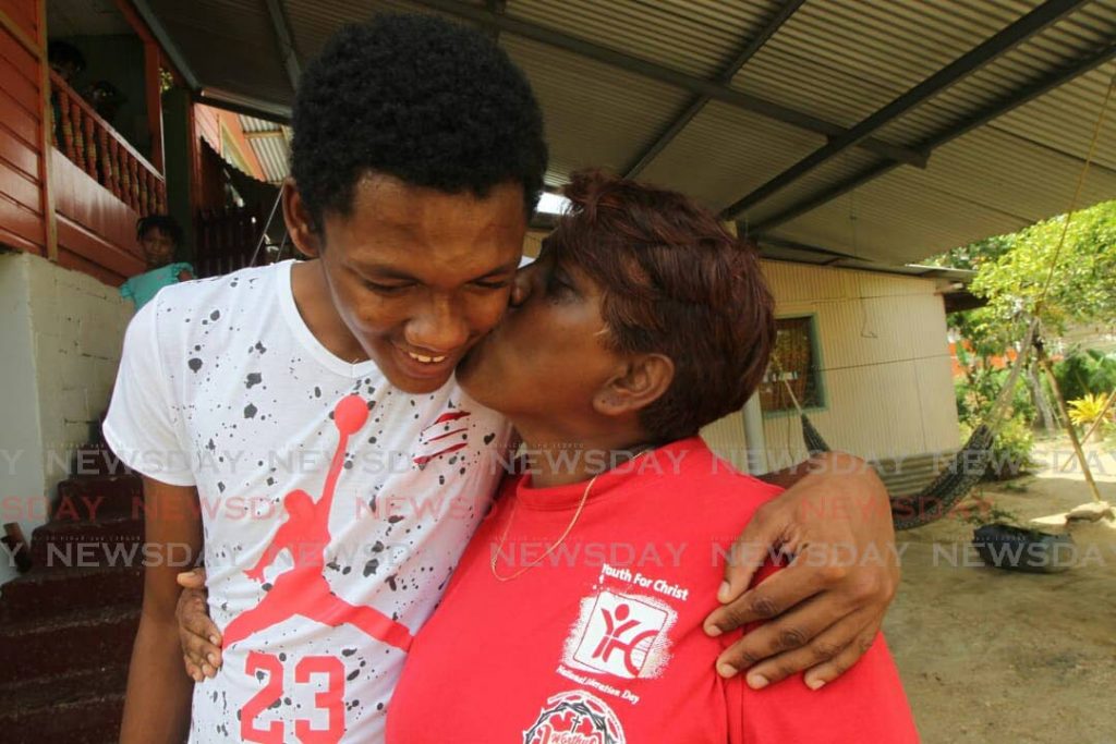 Kenrick Morgan and his mother Linda Boodoo.

Photo: Lincoln Holder