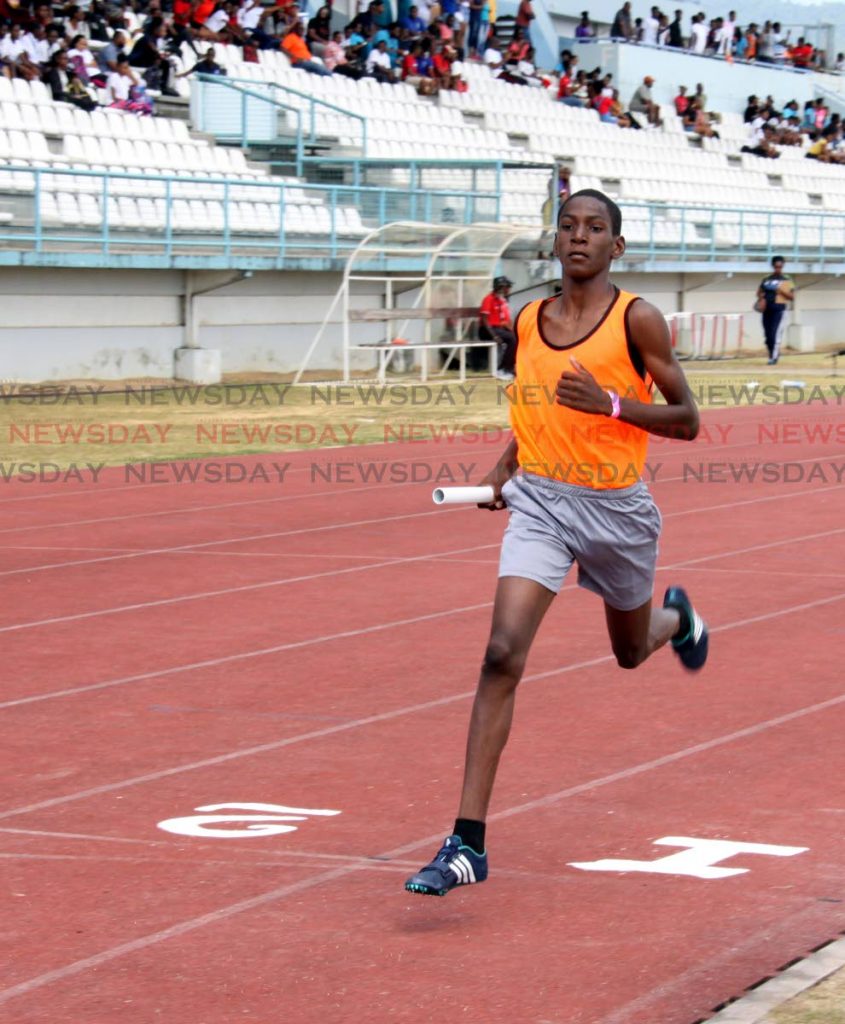 Zeke Mottley of St James Secondary brings home the win for his team in the boys under-13 4x200m event yesterday at the Secondary Schools Relay Festival, Larry Gomes Stadium, Malabar. PHOTO BY ANGELO MARCELLE 