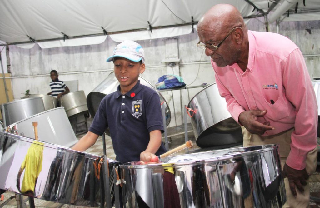 Jalon James plays the double tennor while Flabej director John Douglas looks on, at their Pembroke Street, Port of Spain panyard. PHOTO BY AYANNA KINSALE