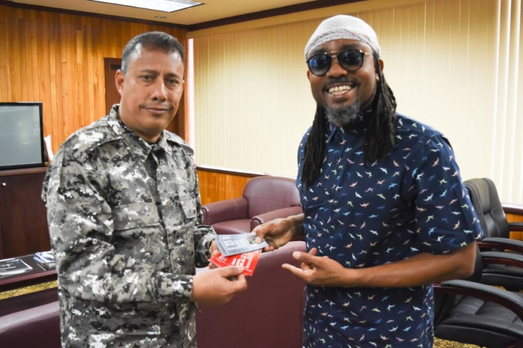 Police Commissioner Gary Griffith, left, receives tickets for Machel Monday from soca star Machel Montano at the Police Administration Building on Sackville Street this afternoon. 
PHOTO COURTESY THE TTPS