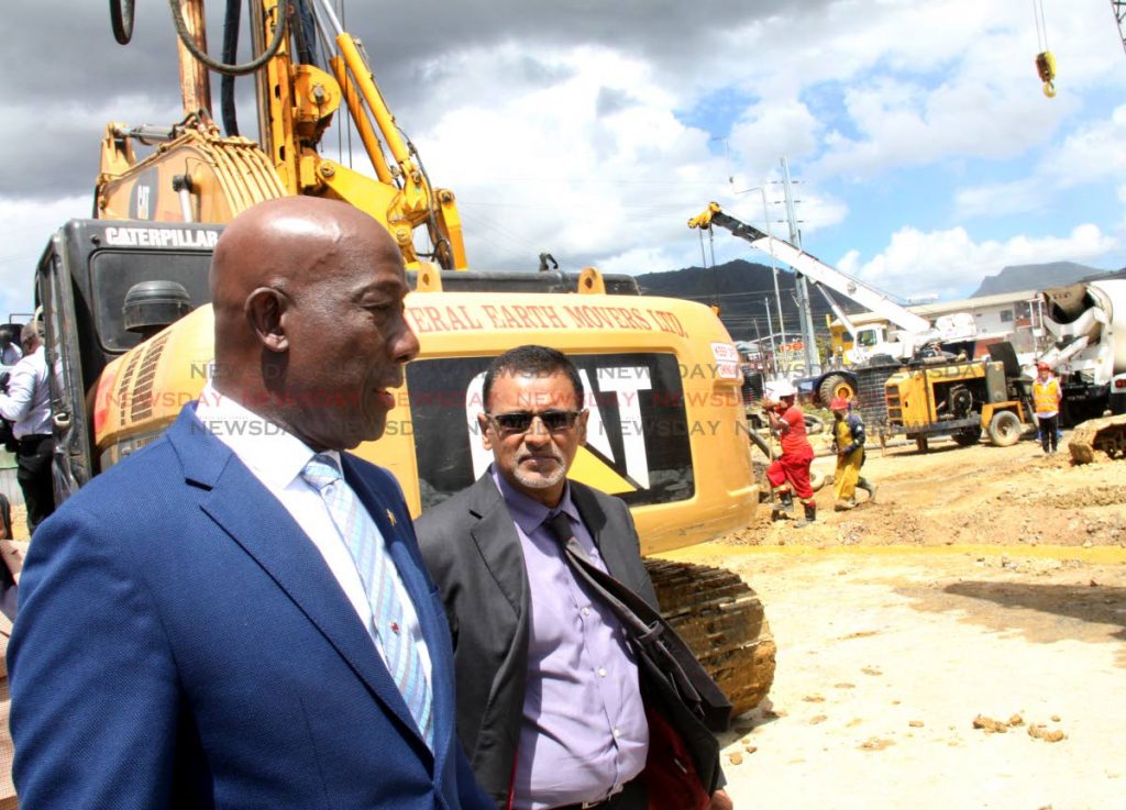 GREEN LIGHT: Minister of Works and Transport Rohan Sinanan, right, and Prime Minister Dr Keith Rowley tour the Curepe Interchange Project after the sod-turning ceremony, yesterday. PHOTO BY ANGELO MARCELLE