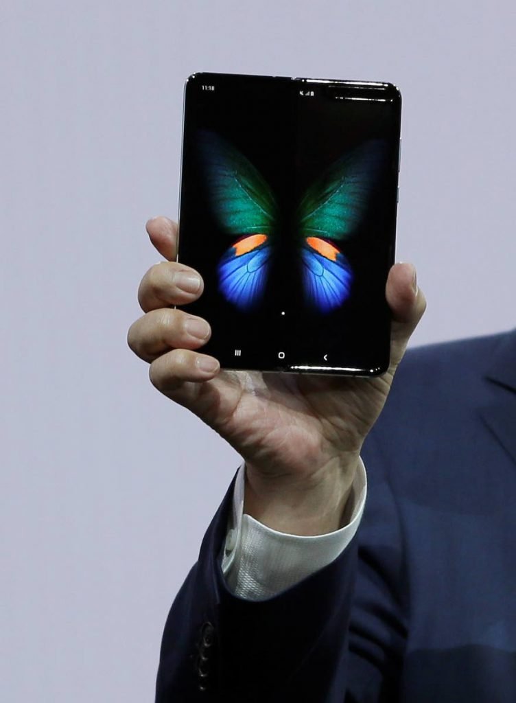 DJ Koh, Samsung president and CEO of IT and Mobile Communications, holds up the new Galaxy Fold smartphone yesterday.