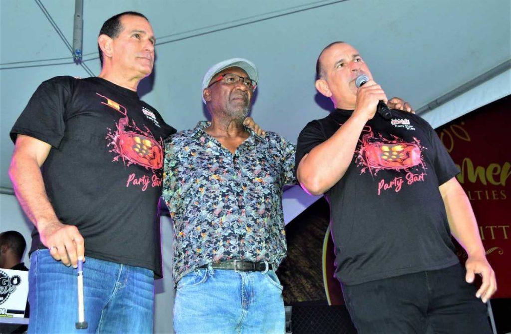 Arranger Len “Boogsie” Sharpe with John and Robert Hadad on stage on Wednesday night at Phase II Pan Groove ‘s corporate lime at its panyard, Hamilton  Holder Street in Woodbrook.