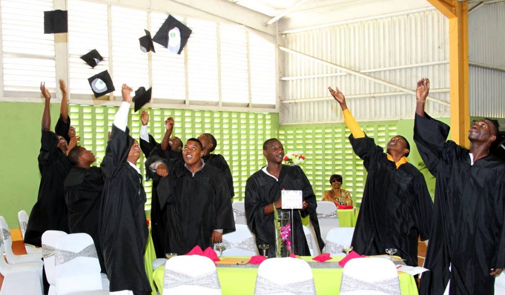 Inmates celebrate graduating from the Caring for Ex-Offenders--Learning for life programme at Youth Training Centre, Arouca yesterday.