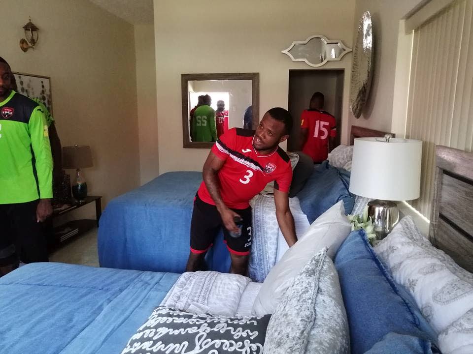 TT defender Jomal Williams checks out a bed at the Home of Football athletes accomodation hotel last Thursday. PHOTO COURTESY TTFA 