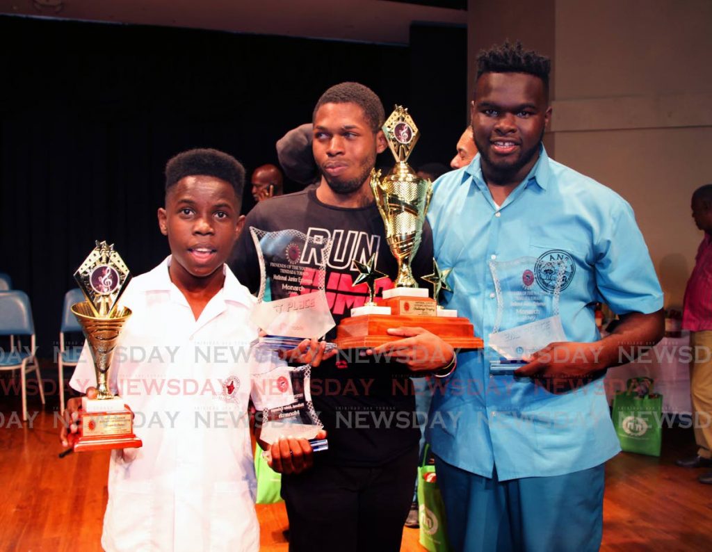 New National Junior Extempo Monarch Keshon Phillip, centre, shows off his trophy along with runner up Isiah John, right, and third place winner Josiah Kennedy after the competition at Cipriani Labour College, Valsayn, yesterday. PHOTO BY SUREASH CHOLAI