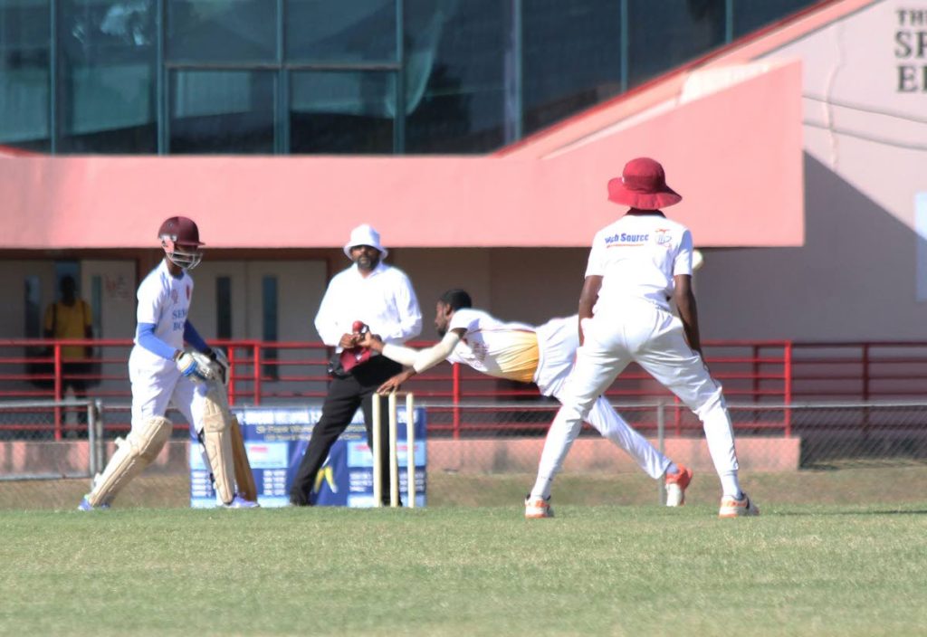 Lemuel Matthews of Shiva Boys Hindu College is caught by Navin Bidaisee of  Hillview College during the PowerGen Secondary Schools Cricket League match held at the Sir Frank Worrell Ground,St Augustine yesterday. 