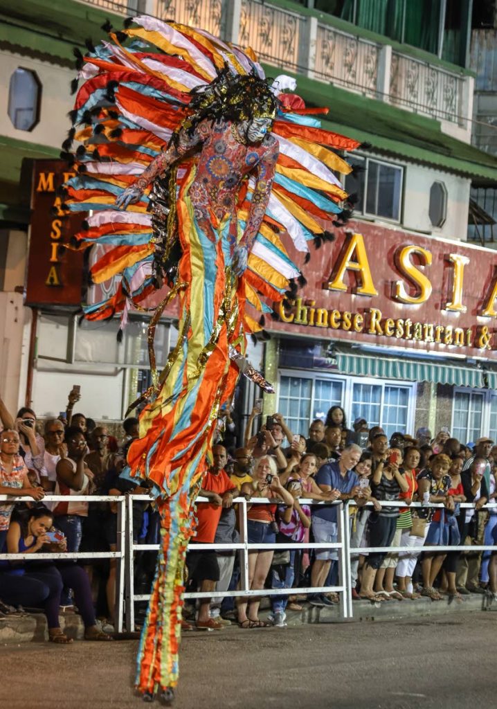 A Blazing Moko portrayed by Tekel Sylvan stands tall at the National Carnival Commission’s Traditional Carnival individual competition at Adam Smith Square, Woodbrook, on Tuesday night.