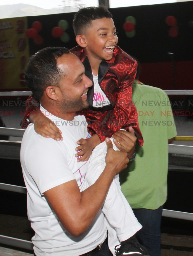 Avindha Singh of Tamana Hindu School, is lifted by his music teacher Rishi Singh, after he won the 2019 School's Intellectual National ChutneySoca Monarch Competition, with his song Take Your Education, in the Primary School category, Grand Stand, Queen's Park Savannah, Port of Spain.

PHOTO:ANGELO M. MARCELLE
27-02-2019