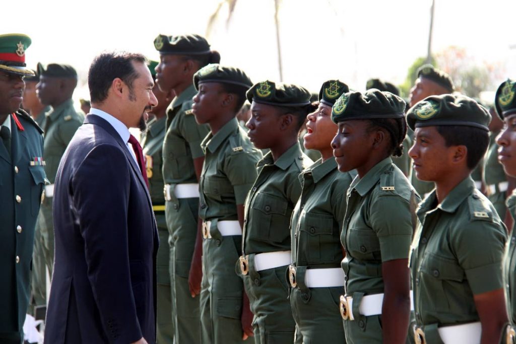 National Security Minister Stuart Young and acting Chief of Defence Staff Darnley Wyke, inspects the ranks of platoon 1801 during a passing out parade at Teteron Barracks, Chaguaramas, yesterday afternoon.   PHOTO BY SUREASH CHOLAI