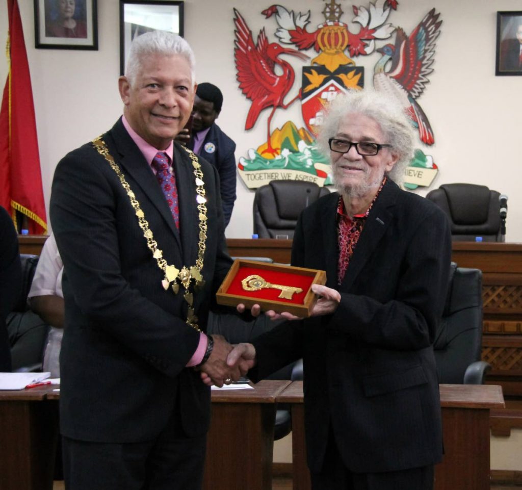 Musician Roy Cape, right, receives the keys to the city of Port of Spain from Mayor Joel Martinez at City Hall on February 8.  File photo