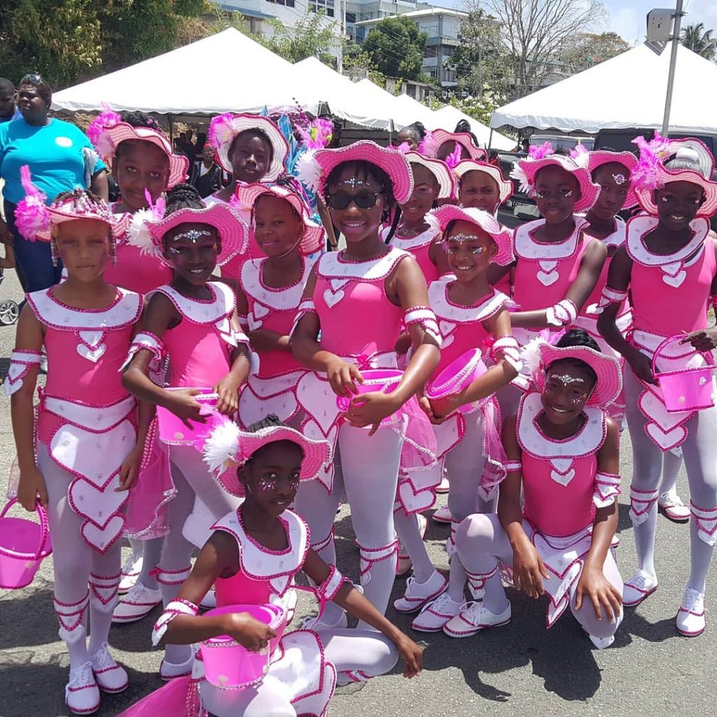 Young masqueraders of the Lover's Bay section of Enchanted Waters get ready to hit the streets of Scarborough during Saturday's Junior Carnival Parade of the Bands.