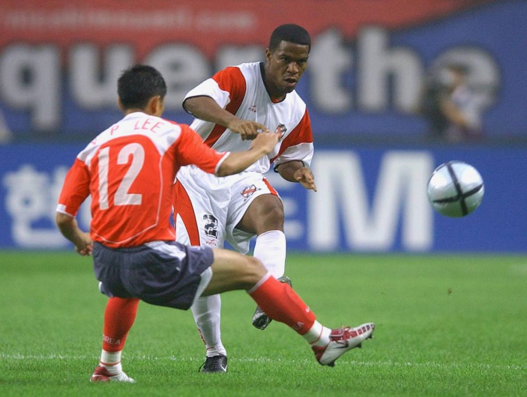Marlon Rojas (R) of TT pushes the ball past South Korea’s Lee Young-Pyo during their friendly football match at Sangam World Cup stadium in Seoul, on July 14,2004.