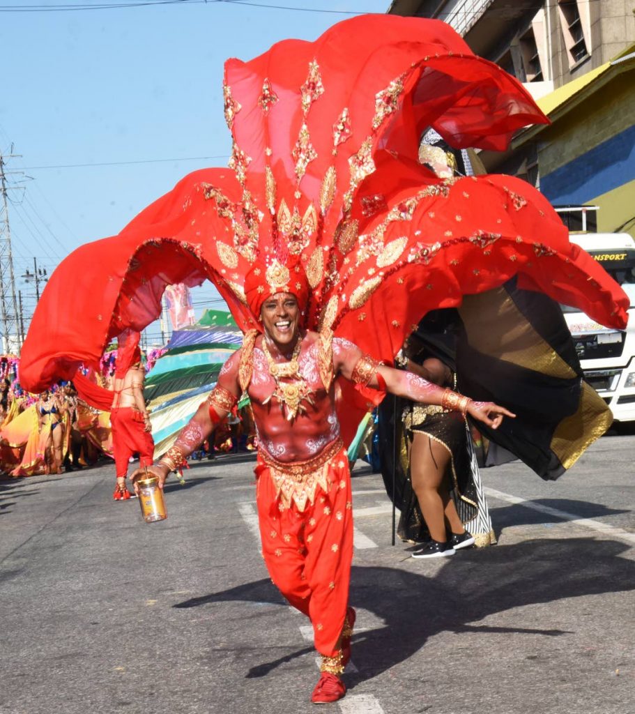A reveller in Lost Tribe's Taj has a ball along South Quay, Port of Spain on Carnival Tuesday. PHOTO BY KERWIN PIERRE