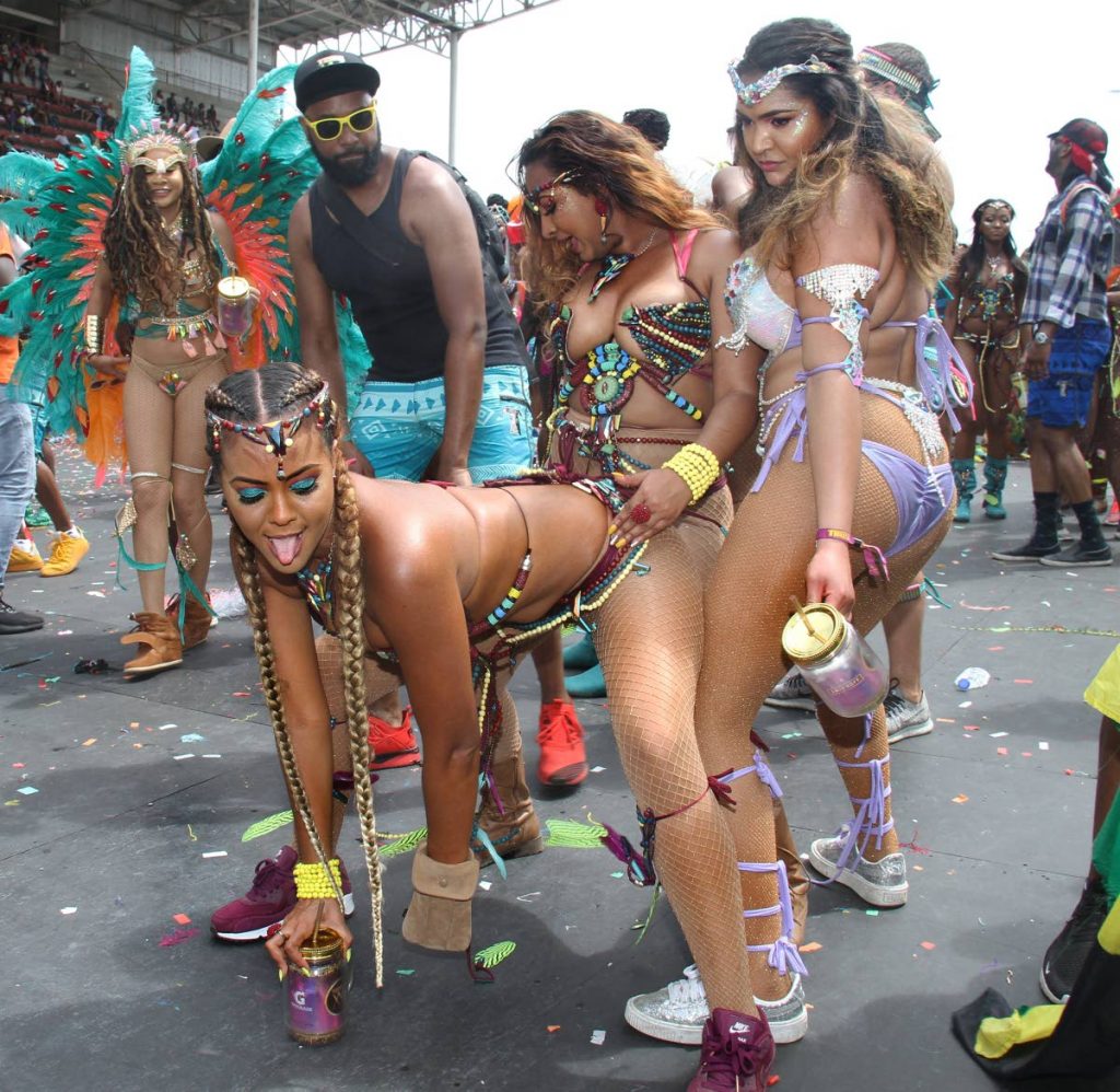 Women masqueraders have their fun in the band Tribe at the Socadrome in Mucurapo yesterday.