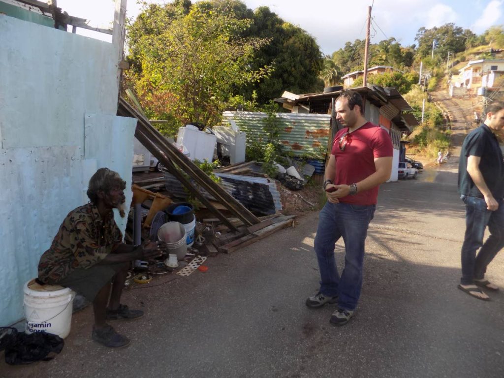 National awardee John Julien, left, speaks to Alderman of the Diego Martin Regional Corporation Paul Nahous, right, during a visit to Julien's maksehift home in Malick. 
Nahous says he is interested in providing building material to renovate Julien's home. 