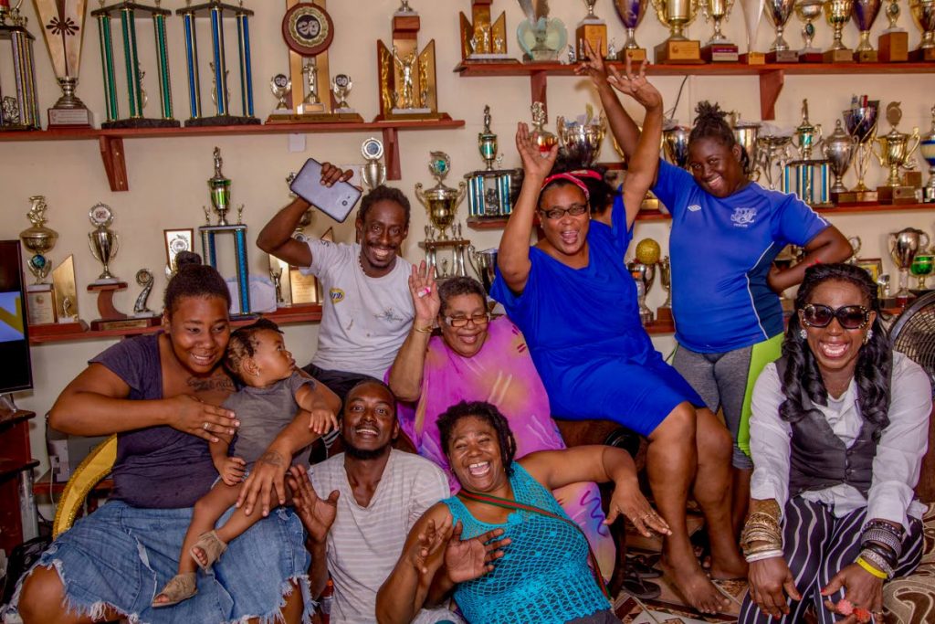 SWEET VICTORY: Stoute Next Generation members celebrate with Gloria Stoute, seated centre, whose Stoute and Associates band gave birth to Stoute Next Generation seven years ago. PHOTO BY DVAID REID 
