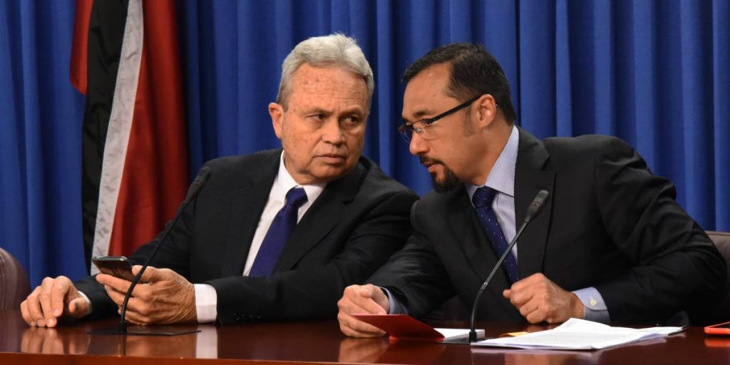HERE'S WHAT TO SAY: Acting Prime Minister Colm Imbert, left, speaks with National Security Minister Stuart Young yesterday at the post Cabinet press briefing at the Diplomatic Centre in St Ann's. PHOTO BY KERWIN PIERRE