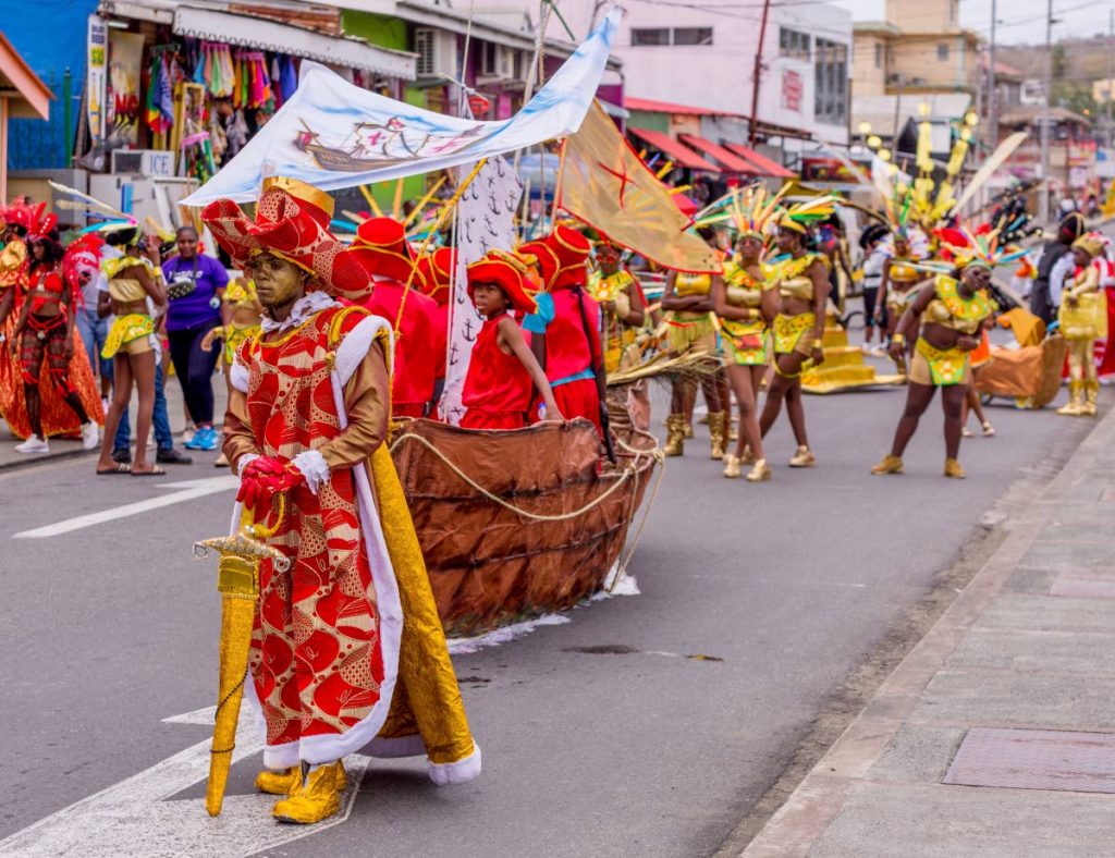 Masqueraders from the Tobago Guild's presentation, Oro: The Story of Gold, cross the stage on Carnival Monday in Scarborough. PHOTO BY DAVID REID 