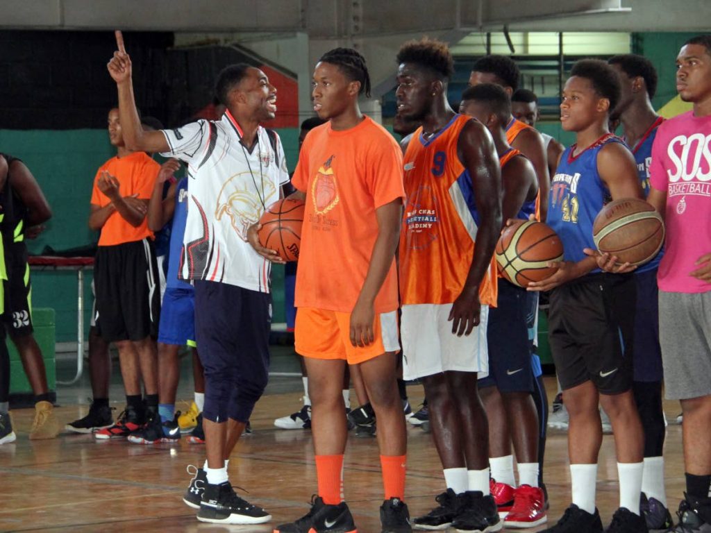 Coach Mark Cook(L), of the United States, talks to participants of the Spartans TT March Mayhem Skills Clinic 2019, yesterday, at the Jean Pierre Complex, Port of Spain.