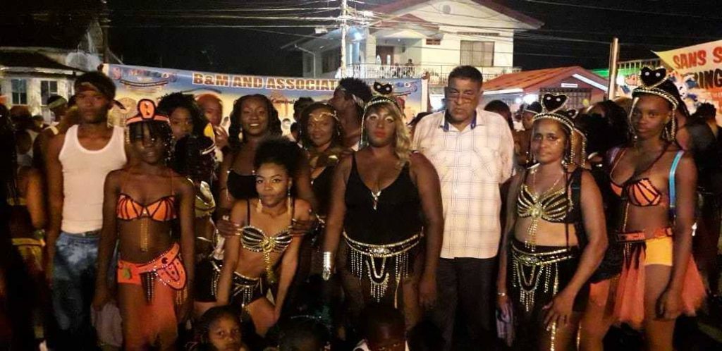 Chairman of the Sangre Grande Regional Corporation Terry Rondon poses with masqueraders on Carnival Tuesday as the corporation hosted one of its most successful and safest Carnival celebrations.