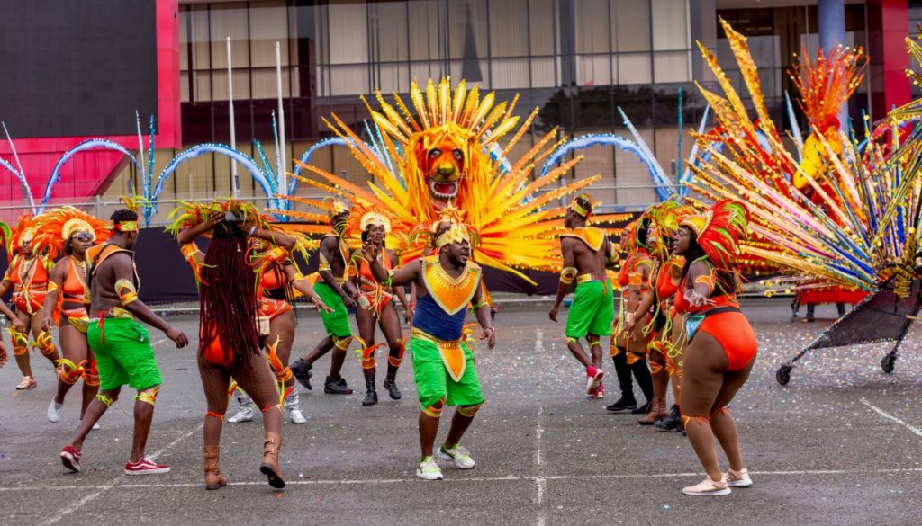Masqueraders from Astra Winchester's mas band frolic in the street on Carnival Monday in Scarborough. PHOTO BY DAVID REID 