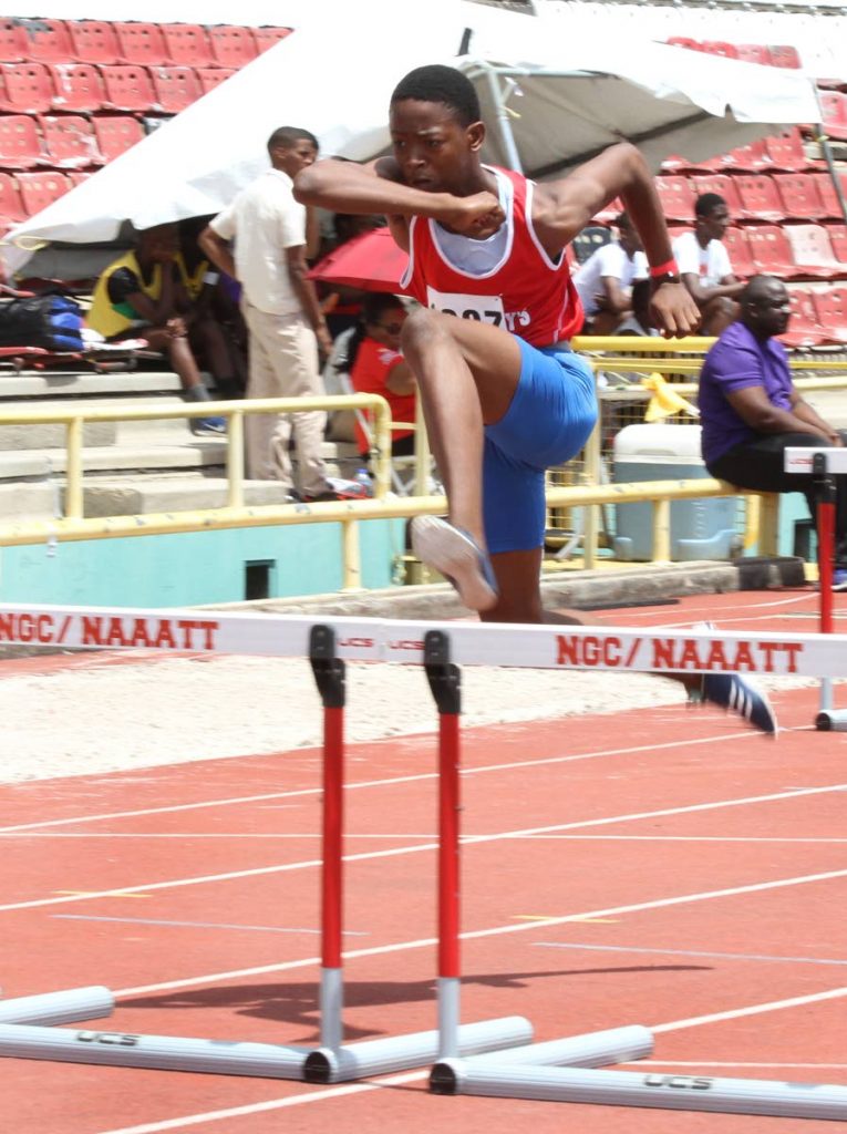 Keone John of St Anthony’s College, easily wins the U15 100m hurdles,yesterday, at the  National Secondary School’s Track and Field Championships, Hasley Crawford Stadium, Port of Spain.