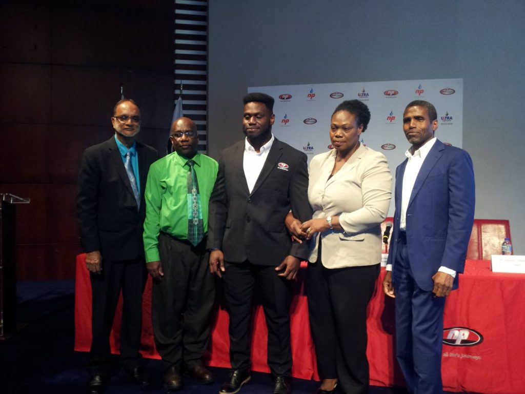 TT powerlifter Rondel Hunte, centre, after becoming a brand ambassador for NP. Also in the photo are NP chairman Sahid Hosein, from left, Hunte's father Ronald, mother Dawn Rodney-Hunte and NP CEO Bernard Mitchell.