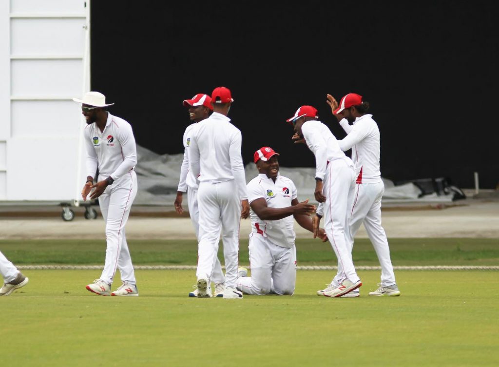 Red Force players celebrate a wicket against the Jamaica Scorpions yesterday at the Brian Lara Academy, Tarouba. PHOTO BY LINCOLN HOLDER
