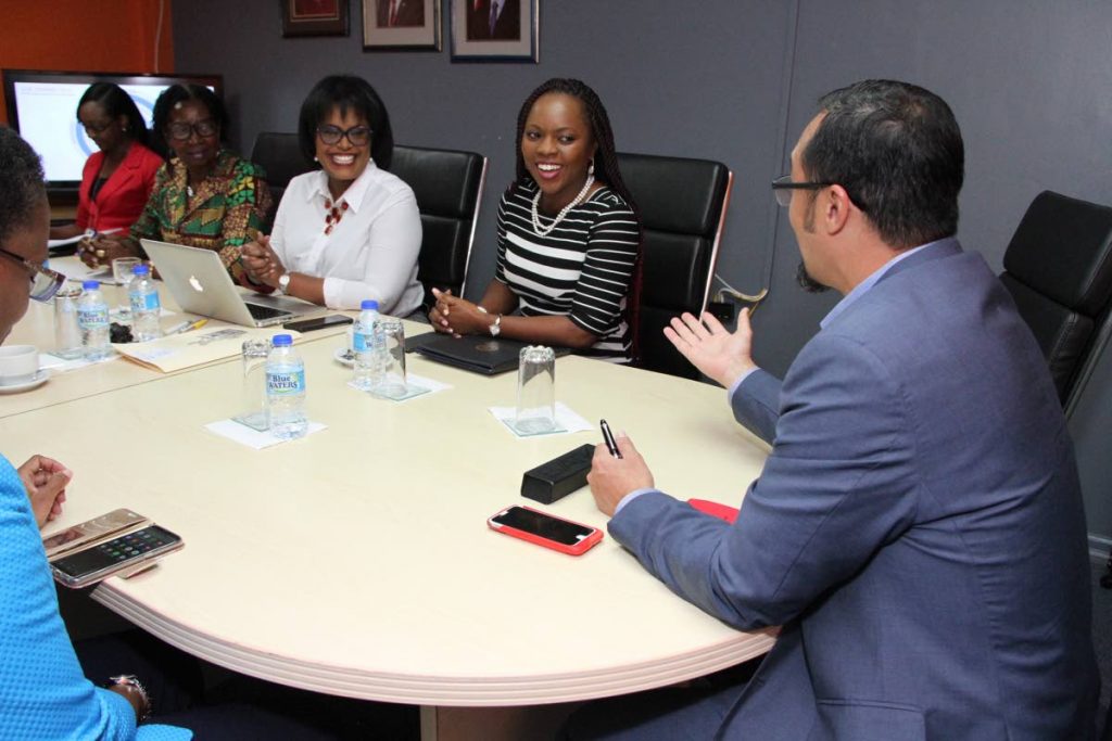 Communications Minister Stuart Young at a meeting with TTT officials. 