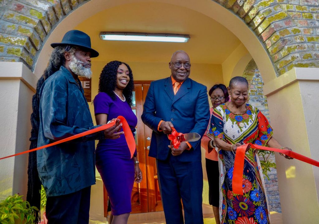 Chief Secretary Kelvin Charles, centre, cuts the ribbon to open the Icons of Tobago Museum, which will feature the works of Calypso Rose, right, and the late Winston 