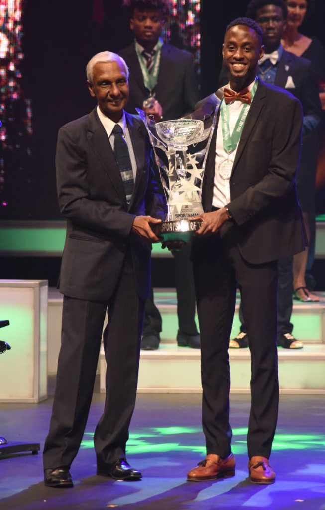 Sportsman of the Year 2018 Jereem Richards, right, collects his award from chairman of the First Citizens Sports Foundation Dr Terry Ali at the awards ceremony on Saturday, held at Queen's Hall, Port of Spain. PHOTO BY KERWIN PIERRE 