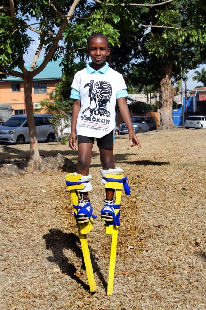 Jaden Rogers practises walking on stilts at Augustus Williams Park, Woodbrook.