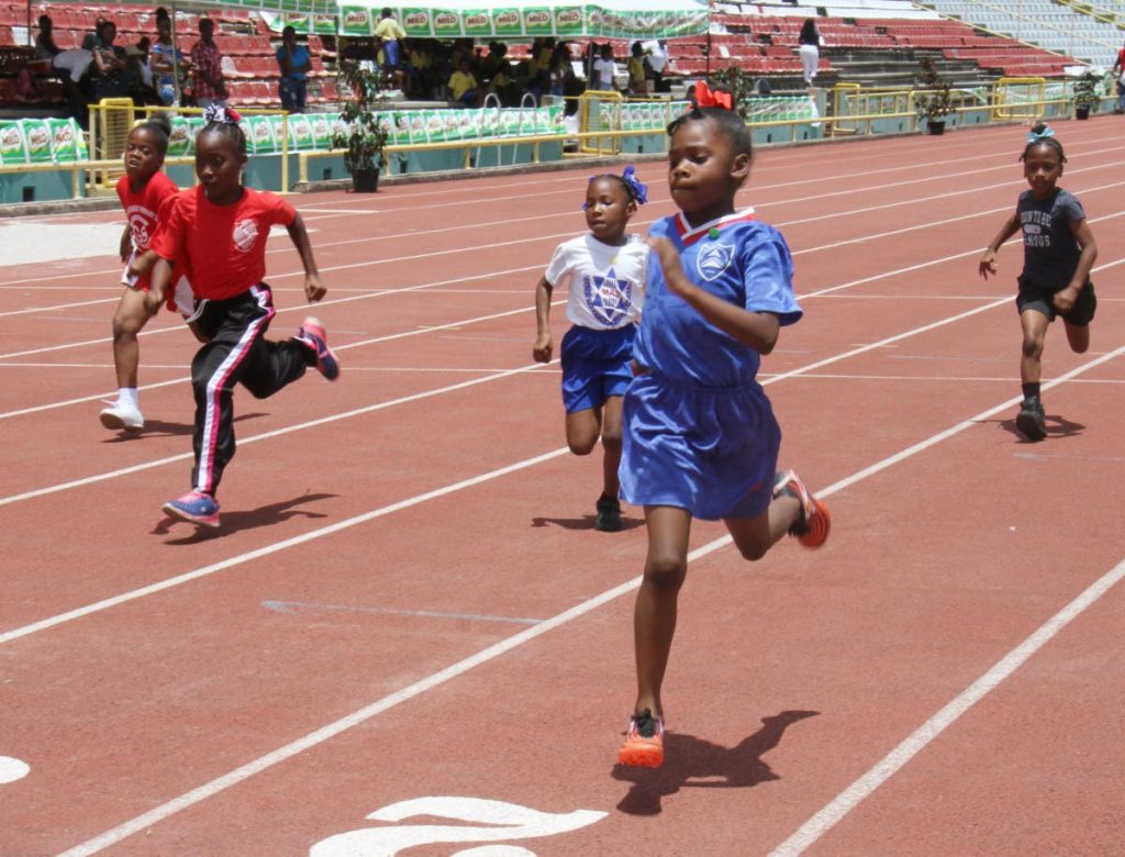 Jennaya Granderson, of St. Dominic’s RC Primary, 2nd from right, goes on to win the Girls Under 9, 80m, at the 32nd Kelvin Nancoo (Milo) Primary Schools Games, Hasley Crawford Stadium, Woodbrook.