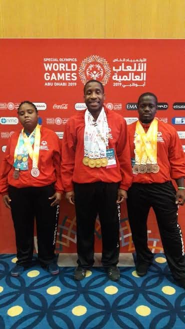 SOTT powerlifting trio Khadafie Anthony,left, Damien Marquis and Damien Brown,right, display their medals after competing at the 2019 Special Olympics, in Abu Dhabi, UAE.