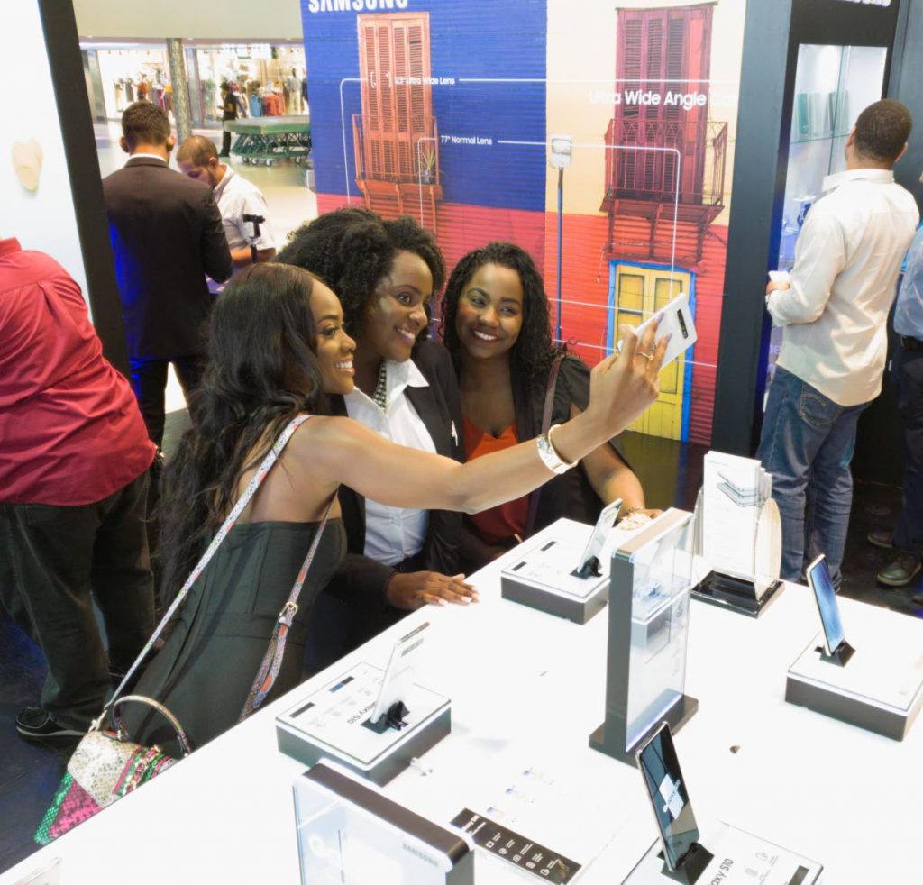 Samsung brand ambassador Avionne Mark, Experience team member Hadassah Gordon, and Rhesa Lessey pose for a wefie with the new wide-angle S10 front facing lens at the launch, Gulf City, La Romaine. PHOTO BY MARK LYNDERSAY

 Photo by Mark Lyndersay. 