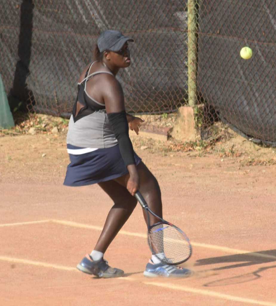 Osenyonye Nwokolo plays a shot against Abigail Jones during the Shell Tranquility Tennis Open,yesterday, at Tranquility Tennis Court, Victoria Avenue, Port of Spain.