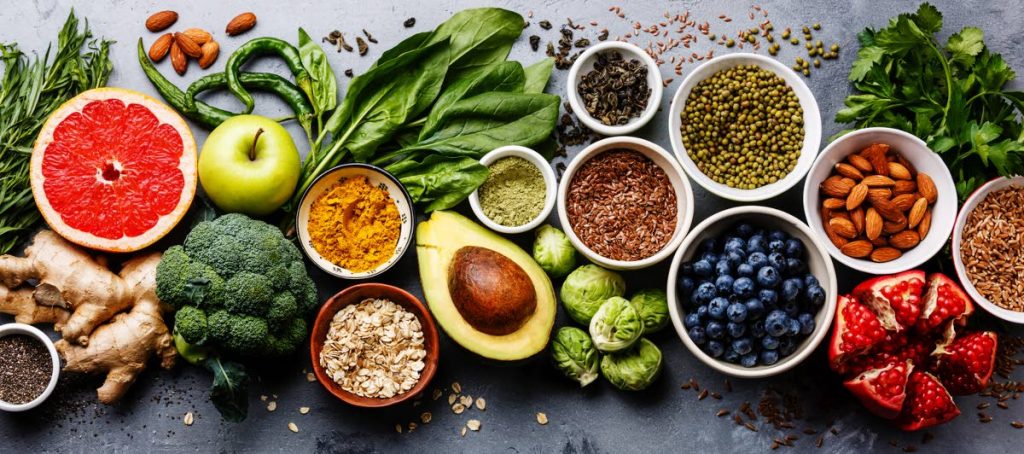 Healthy food clean eating selection: fruit, vegetable, seeds, superfood, cereal, leaf vegetable.