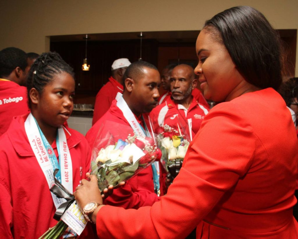 Sports Minister Shamfa Cudjoe (right) meets a member of the Special Olympics TT team during last week's reception at the VIP Lounge, Piarco International Airport.