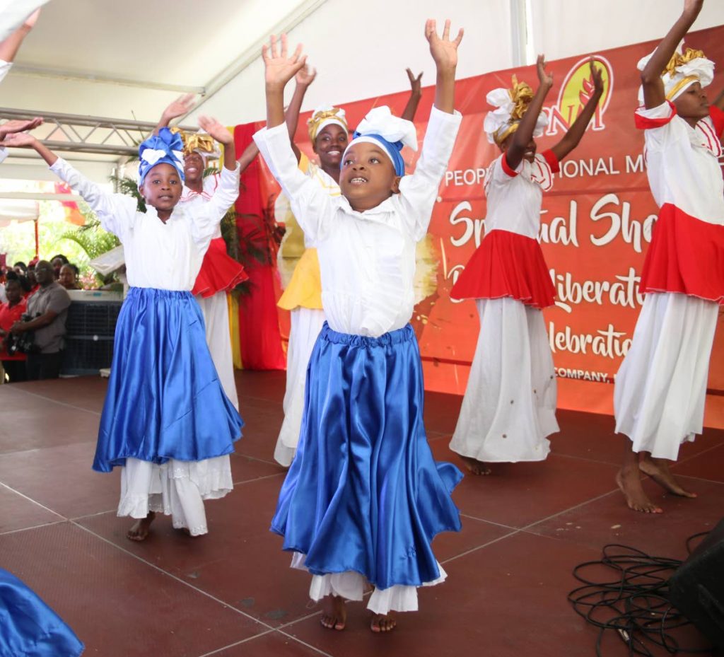 Children dance during Spiritual Shouter Baptist Liberation Day celebrations at Sixth Company Grounds, Moruga.