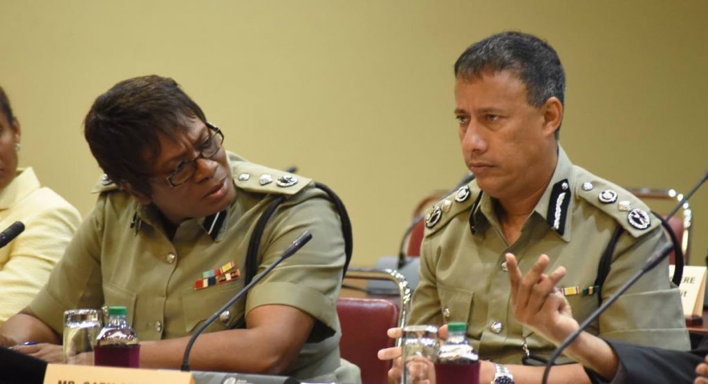 Acting deputy commissioner Erla Christopher chats with  Commissioner of Police Gary Griffith at a Public Administration and Appropriation Committee hearing in Parliament on Thursday. PHOTO BY KERWIN PIERRE.