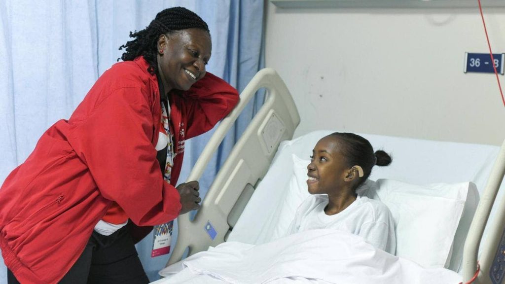 Shanice Baptiste, with an official, at the Sheikh Khalifa Medical City. 
PHOTO COURTESY KHUSHNUM BHANDARI (THE NATIONAL)