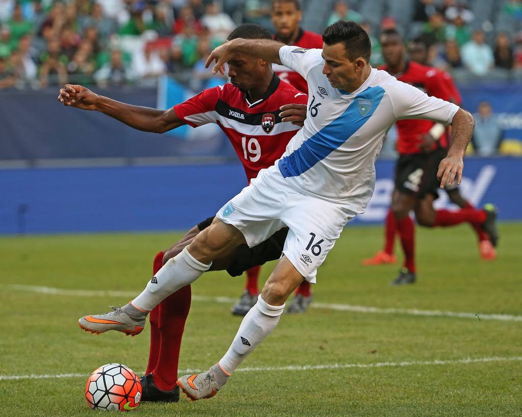 TT midfielder Kevan George (left) fights for the ball with Guatemala's Marco Pappa during a 2015 CONCACAF Gold Cup match at Soldier Field, Chicago, United States.