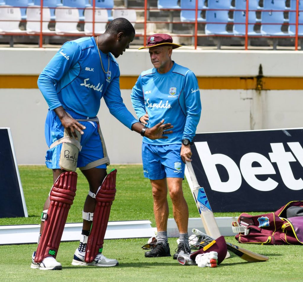 In this file photo, Carlos Brathwaite (L) and Richard Pybus (R) of West Indies take part in a training session one day ahead of the first T20I between West Indies and England, at the Darren Sammy Cricket Ground, Gros Islet, Saint Lucia,on March 4. AFP PHOTO