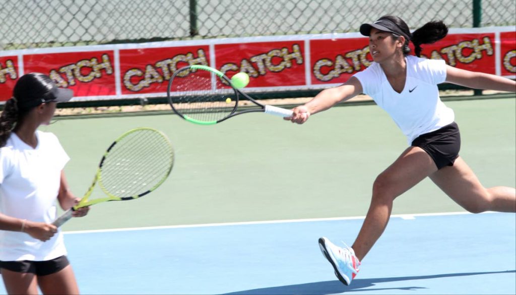 Yin Lee Assang and Cameron Wong in the Girls Senior Doubles semi-finals of the Catch National Junior Championships, at the National Racquet Centre, Tacarigua, yesterday. 
  