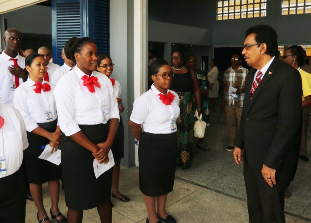 Minister of Local Government and Rural Development Kazim Hosein, right, speaks to the municipal police constable induction trainees at the Marabella South Secondary School yesterday. 