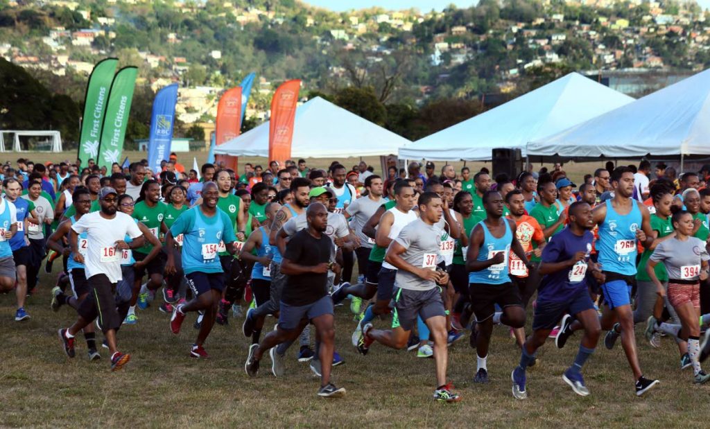 Runners take part in the CariFin Green Mile yesterday, at the Queen’s Park Savannah, Port of Spain.
