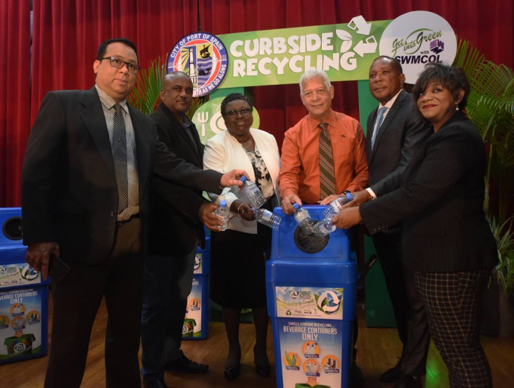 From left: Deputy permanent secretary in the Ministry of Rural Development and Local Government Raymond Seepaul, Port of Spain Corporation transport foreman 2 Dale Agarrat, permanent secretary in Ministry of Public Utilities Nicollet Duke, Port of Spain Mayor Joel Martinez, chairman of SWMCOL Gerry Noel and senior environmental education officer Marcia Tinto took part in recycling plastic bottles during PoS Corporation's Curbside Recycling campaign launch at City Hall on Friday. PHOTO BY KERWIN PIERRE.